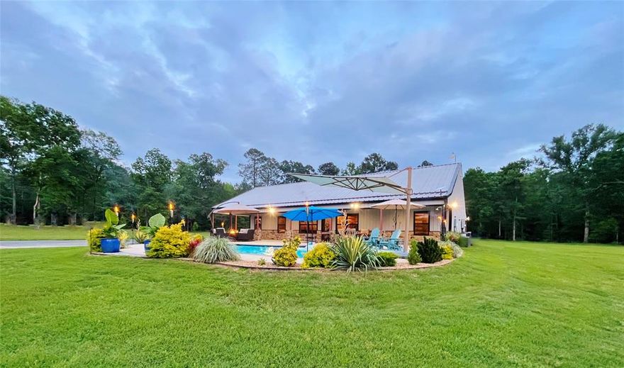Bring All Offers! Furniture (pictured) included with an accepted offer! Tranquil, Secluded, Luxurious. This property is an East TX hidden gems. Enter through the automatic gate and wind your way across NEARLY 40 ACRES that has a perfect mix of towering East Texas pines and pasture. The homesite has a beautiful custom-built barndominium-style 3 bd, 2 bth home with towering ceilings, a laundry room, walk-in pantry, hidden safe room, an industrial-sized Refrigerator and more. The home is completely spray-foamed and paired with an energy-efficient HVAC system. It also features a WHOLE HOME GENERATOR and WATER WELL. Enjoy beautiful, poolside sunsets while in the Heated and Cooled, inground GUNITE POOL or on the lounge deck. Everything needed to maintain the property can be kept in the 60x40 shop featuring 14x14 roll-up doors, tool hangers and a decked 2nd floor storage with an EFFICIENT APARTMENT (could be GUEST QUARTERS). There's also a 50 amp RV HOOKUP! If you’re in the market for the perfect mix of Country and Luxury, this is the property for you.