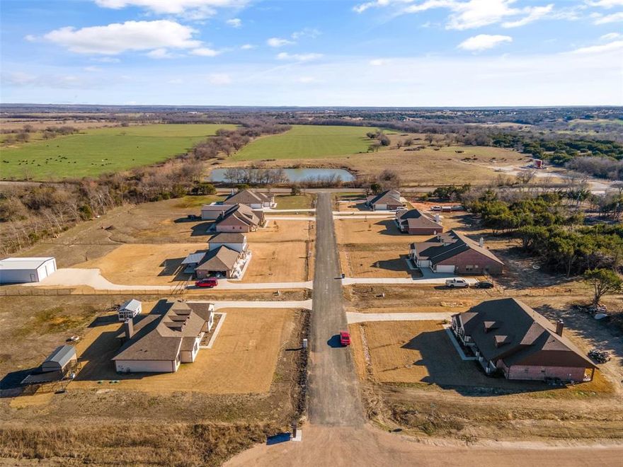Welcome to Westover Hills Phase 2, a charming subdivision with 1+ ACRE LOTS nestled in the heart of Rio Vista, Texas.  
This lot is one of the largest lots in the community at 2.320 acres! Gorgeous custom homes already completed and sold. Drive out and see this scenic community for yourself and pick the lot of your choice to build your very own custom home. Situated southwest of Johnson County, just 45 minutes from the Dallas Fort Worth metroplex, this community invites you to embrace the tranquility of small-town living while savoring the convenience of modern amenities. Escape the hustle and bustle of city life in this peaceful and scenic community that offers NO CITY TAXES, SELECT YOUR OWN BUILDER, PAVED ROADS, EXCELLENT SCHOOL DISTRICT, AND PICTURESQUE SURROUNDINGS. Water meters are very affordable unlike many land developments and lots are ready to go.  ONLY 3 LOTS LEFT TO PURCHASE IN THIS COMMUNITY SO DON'T WAIT!