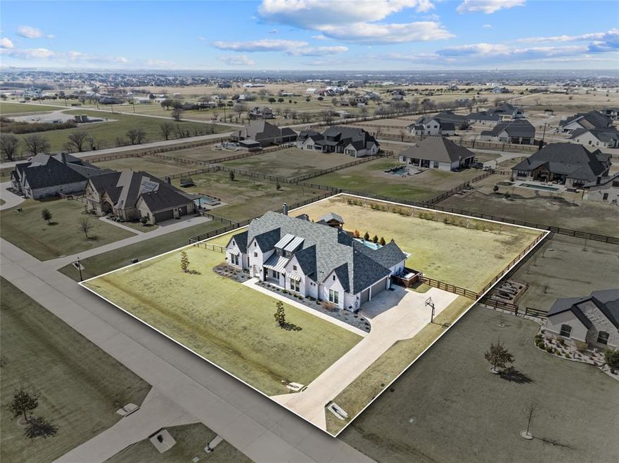 HUGE Price Improvement! Welcome to luxury living in Creek Meadows, located in highly sought after Argyle ISD. This custom home offers over 4500 square feet on 1 acre and delivers the space, layout, and upgrades today’s buyers are looking for. With 5 bedrooms and 5 full bathrooms all on the main level, this floor plan is functional, open, and built for both everyday living and entertaining. Upstairs you will find a spacious gameroom & loft with an oversized closet and abundant attic storage, giving you flexibility for hobbies, media space, or organized seasonal storage.

At the center of the home is a chef’s kitchen featuring a Thermador range, built in refrigerator, double ovens, custom cabinetry, and two oversized islands that open directly to the dining and living areas. Natural light fills the main living space, creating an inviting environment that feels both elevated and comfortable. The primary suite offers a true retreat with a spa inspired bathroom, expansive walk in closet, and upgraded wood flooring that adds warmth and character.

This home goes beyond standard features with a full home generator, surround sound system, and Jellyfish lighting extended around the entire exterior, giving you year round lighting control and added curb appeal.

Step outside to a backyard designed for relaxing and entertaining, complete with a resort style saltwater pool with attached spa and fire bowls, large covered patio with built in screens, and a pergola with outdoor kitchen. Creek Meadows offers a quiet, established setting while still being close to major highways, shopping, and dining. If you are searching for space, upgrades, and a layout that works for real life, this home delivers!