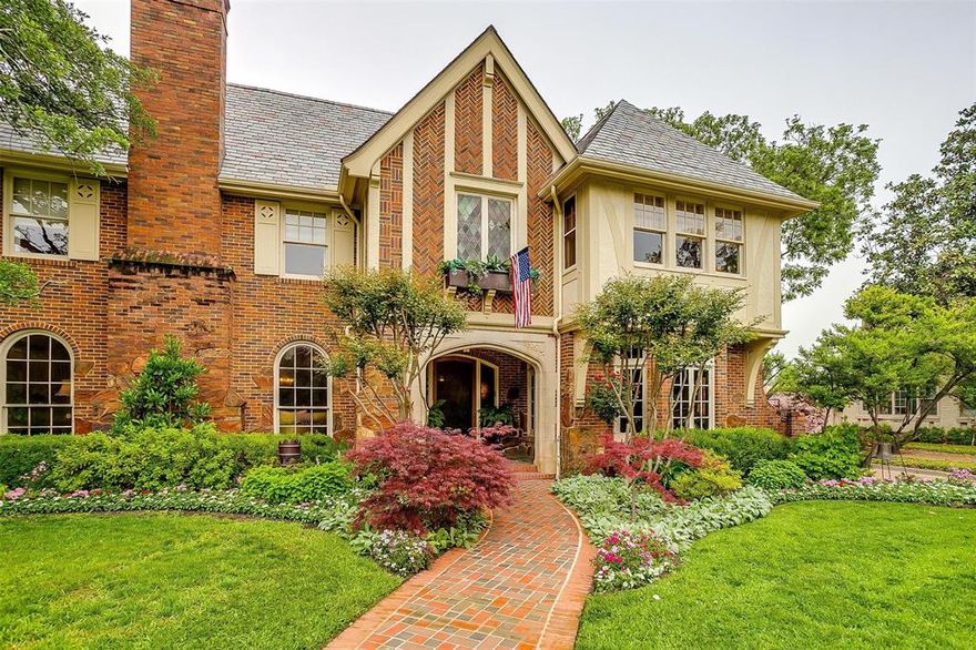 Welcome to 2424 Medford Court West - A rare find in Park Hill. This stunning Early English style estate has been carefully restored in character and original style over the past three decades - with all the updates for modern living. Main house is 5,247 sq ft with 4 bedrooms and 2.1 bathrooms. Features include Tudor arched entry, original call bells and light fixtures, gothic plaster cornice moldings, picturesque windows with Belgian glass, matching interior slate floors with roof (lifetime slate roof replaced 2018), hardwood floors, built-ins, ironwork, elevator, and period detailing throughout. Upstairs, you'll find four spacious bedrooms and two bathrooms. Each bedroom shares an ensuite bath. Primary suite includes a fireplace, adjoining office or hobby space (original sleeping porch). Primary ensuite bath is a true retreat, featuring a separate tub and shower with a window that opens for beautiful view and breeze - perfect for unwinding after a long day! Basement must be seen to believe. Parquet wood floors, wood burning fireplace, full billiards room with original details, and hidden bar! Guest cottage is 475 sq ft, 1 bedroom, 1 bathroom. Studio is 192 sq ft. Gorgeous lush landscaping and tree coverage continue the English Style estate to the outdoors. Covered patio, gardens, and brick walls allow for many spaces for entertaining and privacy.  Pool features coping of bricks from the historic Fort Worth Stockyards. Architect: Joseph Pelich, Features: Texas Home and Living Magazine
