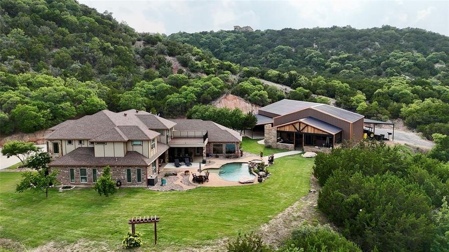 642 Cedar Creek Ranch Trail  Tuscola, TX 79562

Exquisite Cedar Creek Estate with Hilltop Views, Luxury Outdoor Living & Custom Interiors

Welcome to Cedar Creek Estate, a truly remarkable residence situated on a hillside overlooking the Steamboat Mountain Valley. This fully remodeled home is a showpiece of luxury, elegance, and thoughtful design—offering both high-end amenities and breathtaking natural beauty.

As you enter through the grand iron doors, you’re welcomed into a striking foyer featuring cathedral ceilings, a stunning custom stairway, and a wine room to the right. To your left, a formal dining area showcases custom lighting, perfect for elegant entertaining. Overhead, a catwalk connects the upstairs bedrooms and playroom, giving the home a sense of architectural drama.

Straight ahead, the floor-to-ceiling windows in the den frame stunning views of the saltwater pool, hot tub, cascading waterfall, and the scenic hillside beyond. This elegant living space also includes a stone fireplace, custom built-ins, and warm, designer paint tones.

The chef’s kitchen is fully equipped and ready to impress with:

Stainless steel appliances
Large gas cooktop
Built-in microwave
Monogram refrigerator and freezer
Butler’s pantry
Granite eat-in island
Farmhouse sink
Custom cabinetry
Cozy breakfast area

The open-concept kitchen and living room provide a bright, airy atmosphere with exceptional flow for entertaining.

The Master Suite is a true retreat, offering:

A private exterior entry
Wood tray ceiling and milled hardwood flooring
Private office space
Spa-like ensuite with dual granite vanities, jetted garden tub, pillared accents, and a walk-in tile shower with multiple shower heads
A large custom walk-in closet with a built-in safe room


Upstairs, you’ll find:
Additional bedrooms and ensuite baths
A spacious playroom
A theater-media room

See Additional Documents for full Write up