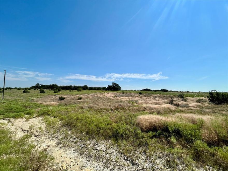 Uncover the ideal foundation for your dream home on this generous 2.18-acre parcel, situated within a tranquil gated community just minutes away from the lively pulse of Downtown Stephenville. This remarkable property presents a unique chance to savor the best of country living while still being close to urban conveniences. Picture waking up each morning to breathtaking panoramic views, with minimal building restrictions that empower you to design your perfect home. Whether you’re imagining a quaint getaway or an expansive estate, this lot is primed for your vision to unfold. The community boasts a delightful shared area featuring a picturesque arbor and a pickleball court, perfect for connecting with neighbors and relishing the outdoors. Essential utilities are already established, including power lines, with fiber optic internet on the horizon to keep you seamlessly connected. Individual landowners will need to set up their own septic and well systems, allowing for a tailored approach to suit your lifestyle needs.