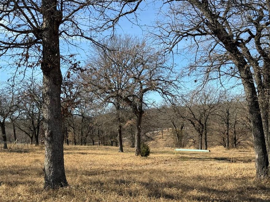 This 10.62 acre tract has Coastal Bermudagrass with many mature trees, a creek, a pond, a 30x60 barn and two, 20 ft storage containers. This property has several building sites or great for grazing.