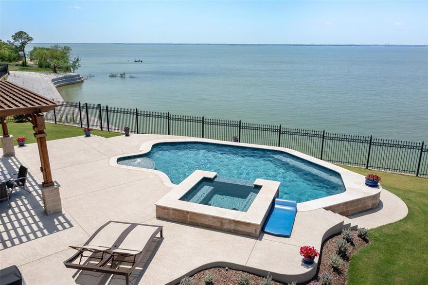 STUNNING LAKEFRONT home on Lake Lewisville! Rare opportunity in sought after Tribute Resort Style Community! Spectacular Sunset Views!!! Immaculate home with open floor plan, court yard entry, wood floors, double sided fire place, study with French doors and custom built-ins, formal dining area with built in hutch perfect for entertaining. Chef’s dream kitchen offers large island with additional storage, SS appliances, double ovens and eating area. Extended covered patio with newer swimming pool and spa, electric screens, outdoor kitchen area with built in grill and gorgeous pocket glass doors up and down offering lots of natural light and amazing views! Desired floor plan featuring 3 bedrooms with en-suites and additional powder batch and media room down stairs, upstairs you will find a 4th bedroom with a full bath, large game room, powder bath and upper balcony area with unbelievable views. Access to the Waterford Point Club House specifically for this community.