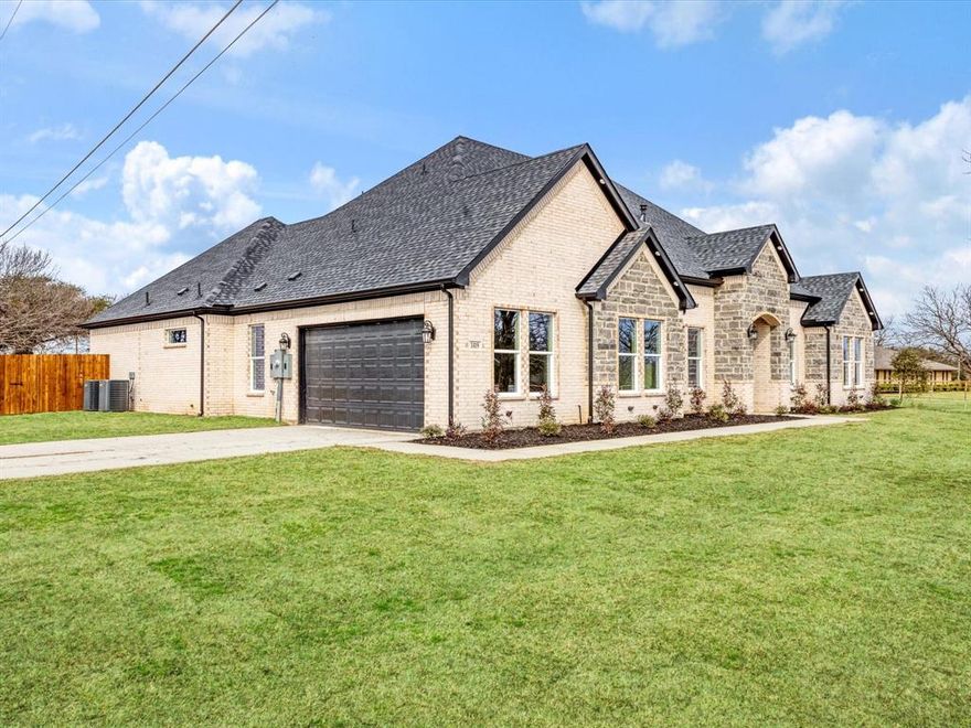 Stunning new construction situated on approximately 0.74 acres in Combine, Texas. This beautifully designed home offers the perfect blend of modern luxury and peaceful country-style living, all within convenient reach of Dallas and surrounding areas.

The striking stone and brick exterior, expansive front lawn, and extended driveway create impressive curb appeal from the moment you arrive. Inside, soaring vaulted ceilings with exposed wood beams anchor the open-concept living space, while oversized windows and double French doors flood the home with natural light.

The spacious living room flows seamlessly into a designer kitchen featuring custom cabinetry, quartz countertops, a large island with seating, built-in stainless appliances, under-cabinet lighting, and a walk-in pantry. The layout is ideal for both everyday living and entertaining.

The primary suite offers a private retreat with a spa-inspired bath showcasing dramatic marble-look tile, a freestanding soaking tub, oversized walk-in shower with glass enclosure, and dual vanities. Secondary bedrooms are generously sized and thoughtfully positioned for privacy. A large utility room with additional cabinetry and workspace adds everyday convenience.

Step outside to a covered back patio overlooking the expansive backyard with endless possibilities — room for a pool, workshop, garden, or additional outdoor living. With nearly three-quarters of an acre, there is space to spread out and enjoy.

Quality craftsmanship, modern finishes, and land to breathe — a rare opportunity.