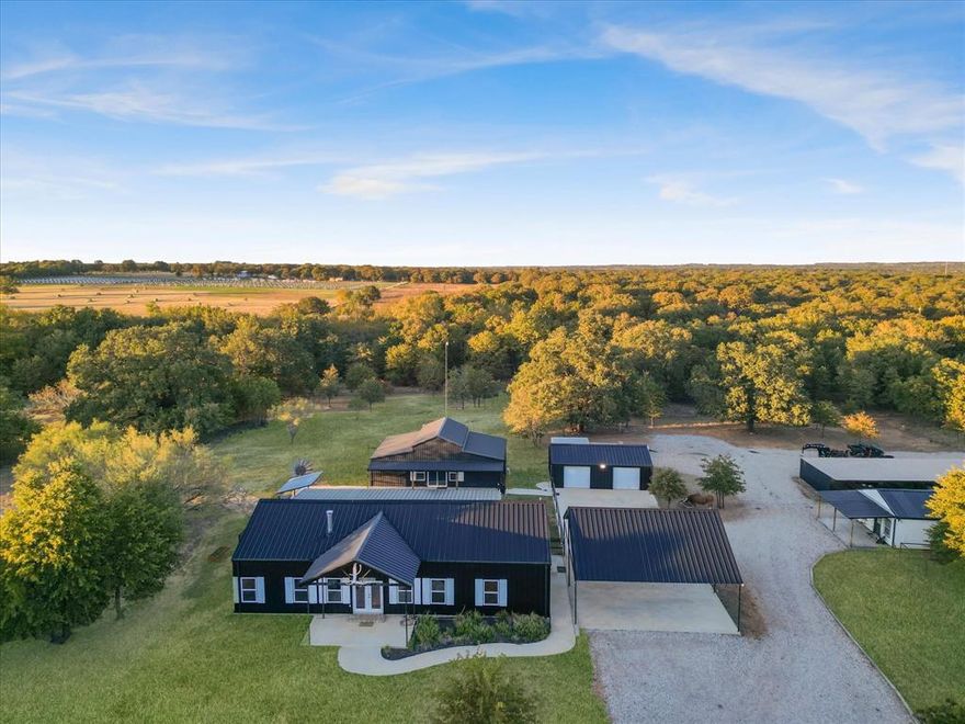 Exceptional opportunity to own a fully high-fenced 84-acres private ranch estate in Parker County, offering a rare blend of luxury living, recreational land, and income-producing potential. Surrounded by rolling terrain, mature trees, and expansive Texas skies, this remarkable property delivers privacy, natural beauty, and the true spirit of Texas ranch living.The ranch has previously operated as a successful guided hunting destination generating income annually, with infrastructure already in place including shooting houses, protein feeders, corn feeders, and established wildlife management systems. Native and exotic wildlife currently on the property include Whitetail, Axis, Blackbuck, Aoudad, Sika, wild hogs, and Texas Longhorn, creating an exceptional recreational and hunting environment.
The main residence is a thoughtfully designed 3-bedroom, 2-bath metal home offering approximately 1,800 sq ft with an open-concept layout connecting the living, dining, and kitchen areas. A cozy fireplace anchors the living room while large windows bring in natural light and showcase scenic ranch views. Expansive covered front and back porches provide peaceful spaces to enjoy wildlife sightings and stunning Texas sunsets.

Outdoor living is highlighted by a resort-style beach-entry, chlorine in-ground swimming pool, ideal for relaxing or entertaining guests.
Additional improvements include a 1,000 sq ft 2-bed, 2-bath guest cabin or pool house, a separate 1-bed, 1-bath residence with covered porch, detached two-car garage, and a 125x20 covered carport for equipment and vehicle storage. The land also features two ponds, water well, and cleared perimeter access roads. Whether you are searching for a luxury ranch retreat, a recreational paradise, a hunting destination, or a long-term investment, 7601 Zion Hill Rd offers an opportunity that is both rare and remarkable.
This exceptional Parker County ranch represents more than just a property.