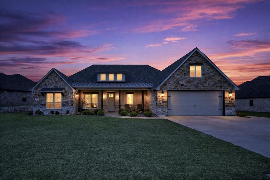 Welcome to this exquisite 4-bedroom, 3-bathroom brick and rock home nestled within the prestigious Pecan Plantation gated golf community. Designed for comfort and elegance, this residence boasts an open-concept layout with split bedrooms, offering both space and privacy. 
Key Features: Gourmet kitchen with beautiful, leather-grained counter tops is equipped with SS appliances (plumbed for an icemaker), an impressive island, and double oven—perfect for entertaining. Home is cozy and inviting; windows provide a light-filled atmosphere. Handsome stone fireplace with gas logs creates a warm ambiance in the spacious living area with loft. Woodplank design ceramic tile in main living areas and plush carpet in bedrooms for comfort. This energy efficient home features spray foam insulation and a Trane HVAC system to ensure year-round comfort and savings. Fully sprinklered lawn with easy care, attractive flowerbeds, and a fenced backyard for children and pets. Oversized 2-car garage has a dedicated golf cart space and separate golf cart door. These owners have a walk-in storm shelter in garage equipped with lights and all necessities. Home is conveniently located near Pecan Plantation’s top-tier amenities, including golf, pools, parks, and more. Just minutes from Lake Granbury and the charming Hood County Square, with its boutique shops, restaurants, and lively weekend events. An easy hour’s drive to downtown Fort Worth for outings. This home is a perfect blend of luxury, comfort, and resort-style living. Don't miss the chance to make it yours! Schedule a private tour today!