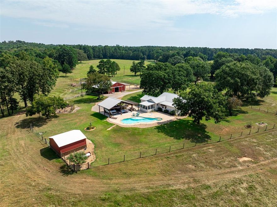 This turn-key retreat or primary home, residential farm has beautiful views overlooking the park like forests and pastures that this area is famous for. There are two separate houses, each with a separate entrance. The 2,100-sf primary house located at 5624 E FM 323 is accessed through a beautiful code entry gate, and down a long tree lined-covered drive to the home beautifully remodeled by the current owners. It is a one-story home with brick and siding exterior and metal roof. The open layout of the house is ideal for entertaining with a large kitchen. There are several patios overlooking the swimming pool and outdoor kitchen. Cooking in both the main house and the outdoor kitchen is fueled by propane gas. The primary bedroom suite has a large bathroom with shower, separate sinks, and a large walk-in closet, overlooking the yard. A study-sunroom and the two guest bedrooms are all accessed off the main across the great room. There is a 2-car carport overlooking the pool area and that can double as a party pavilion. Near this house is a horse barn with 3 stalls, tack & feed room, and shop area large enough for parties and storage. The barn is connected to a generator. 
The 2,000-sf guest house located at 5730 E FM 323, has a separate entrance off the road and is only a couple hundred yards away as the crow flies. The one story, brick guest house has a kitchen with an island that overlooks the large open living area and adjacent living room. There is an adjacent 3 car carport with attached shop all covered by a metal roof. In the backyard there are fenced vegetable gardens. There is perimeter fencing as well as cross fencing with Net wire on the property. The farm attracts a variety of wildlife due to the numerous creeks, draws, and wooded areas on the property. There are many trails throughout the property. 
There is a 68 AC farm on the southwest side of this property, For Sale and list by this Broker. See MLS # # 21061880 for more information.