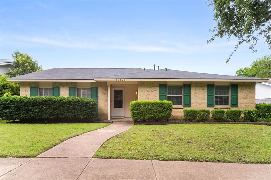 Endless potential in highly sought after Highland Meadows! This inviting ranch style home features a flexible, well-designed floor plan with room to live, entertain, and personalize. The street is lined with mature trees canopy greeting you every time you come home. Inside, the layout offers incredible versatility beginning with a combined living dining space anchored by a fun retro 1970s bar; complete with generous storage and counter space for hosting. A second living area includes a breakfast room, galley kitchen, and cozy den with fireplace and sliding glass doors that lead outside. The kitchen features a pass through window to the covered back patio, tons of counter and cabinet space plus a funky old school cool vibe. Three comfortable secondary bedrooms share a hall bath, while the oversized primary suite offers great space and a large walk in closet. Low maintenance lvp flooring flows through out home. The backyard is fully private with wood fencing; ideal for play, pets, or relaxing outdoors. An attached two car garage with alley access adds convenience. Located in Richardson ISD and zoned for desirable Lake Highlands High School. This gem is waiting for you to add your sparkle!