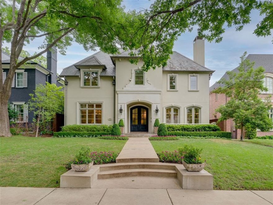 The warm transitional style of this Highland Park home has broad appeal. Foyer is flanked by a dining room and large living area with adjacent butler’s pantry, perfect for entertaining. Warm hardwood floors and 11ft ceilings throughout lower level of the home. Kitchen features Wolf and Subzero appliances, dual dishwashers, oversized quartzite island, and additional butler’s pantry. Spacious den and great room have French doors opening to a terrace with automated screens. Primary bedroom features limestone fireplace and French doors leading to a Juliet balcony. Four additional bedrooms on upper level. Features of home also include a slate roof, elevator, and third floor attic space. The yard, with mature landscape and privacy, has heated spa, cast stone fireplace, outdoor kitchen, and landscaping by Harold Leidner. Unparalleled location close to several parks, the shops and restaurants of HP Village, the Katy Trail, and Armstrong Elementary School.