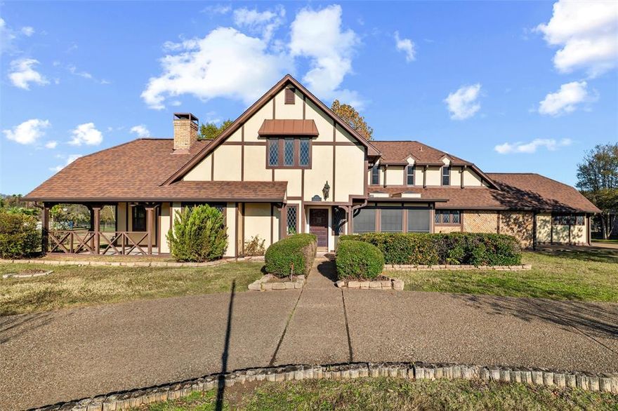 Welcome to this beautiful English Tudor home OUTSIDE  the CITY LIMITS with so much character! This two-story home offers a living room with a wood burning fireplace and an office with built-ins and its own private entrance; perfect for an in-home business. The home features an eat-in kitchen, a dedicated dining room, plus a sunroom that could also be additional dining. There are TWO primary suites, both have en-suite baths. The downstairs primary could easily serve as an in-law suite, guest retreat, or multi-generational living! Outside, the property overlooks a meadow on OVER 2 ACRES plus a pond! Enjoy your own outdoor oasis with a covered back porch and a sparkling pool; perfect for cooling off on hot Texas summer days or hosting unforgettable gatherings. Brand new carpet and brand new painting throughout the home as of November 2025. Enjoy the tranquility of a quiet community paired with outstanding neighbors. Discover all this property has to offer and make it your next home!