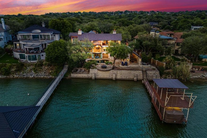 Luxury waterfront living reaches a new level in this truly one-of-a-kind custom estate on Eagle Mountain Lake. Perfectly positioned to capture some of the most breathtaking panoramic water views on the lake, this extraordinary property was designed so that every bedroom — along with the private office — enjoys stunning lakefront views. From the moment you enter, the home makes an unforgettable impression with a dramatic waterfall feature, intricate handcrafted ironwork, and a grand staircase that sets the tone for the exceptional craftsmanship found throughout. Rich mesquite wood floors, travertine finishes, soaring architecture, and walls of glass create a seamless blend of elegance and warmth while framing the water from nearly every angle. The secluded primary retreat is a private sanctuary featuring a fireplace, serene lake views, private study, cedar closets, and a spa-inspired bath designed for relaxation. Designed for both entertaining and everyday luxury, the outdoor experience is unmatched. Enjoy your resort-style pool overlooking the water, private covered boat dock with lift, and an incredible lakeside cabana complete with an outdoor kitchen, grill, and fireplace — all curated for unforgettable evenings on the lake. A separate guest quarters with private entrance and full bath offers ideal accommodations for visitors or multigenerational living. This is more than a home — it’s a legacy waterfront estate offering unmatched views, timeless craftsmanship, and the very best of Eagle Mountain Lake living.