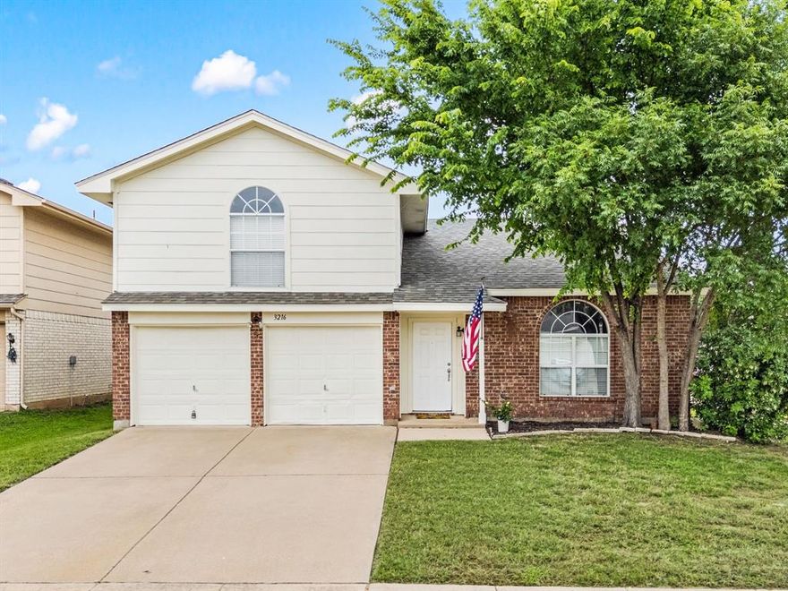 Tucked into the sought-after Lakes of River Trails masterplanned community, this spacious Hurst home offers an ideal blend of comfort, flexibility, and convenience! Just 2 blocks from the community’s stocked fishing lake, playground, and picnic area, you’ll love the neighborhood lifestyle and easy access to Fort Worth, Grapevine, Arlington, shopping, dining, and major highways and blocks from the Trinity Lakes train station for the TRE .

Designed with a versatile multigenerational layout, the home features 2 private primary suites at an amazing price point. A first-floor primary suite plus 2 additional downstairs bedrooms, while the upstairs offers a second primary suite and large game room perfect for guests, teens, or extended family living. The inviting living room showcases a soaring vaulted ceiling and cozy fireplace, creating a warm and open gathering space.

The granite kitchen offers abundant workspace and storage, while recent updates including a new roof and fresh paint provide peace of mind. Step outside to enjoy the oversized concrete patio with plenty of grassy backyard space for pets, play, or entertaining and a sprinkler system. Complete with a 2-car garage and located in one of Hurst’s most convenient communities, this home combines space, function, and location in one exceptional package!