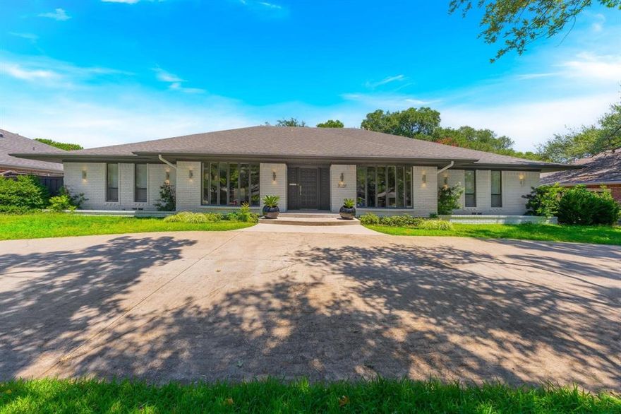 One Story Ranch Windsor Park Preston Hollow - offering 4 beds, 3 living areas, 3 full & 2 powder baths, 2 car attached garage & great outdoor entertaining space; kitchen offers built-in commercial sized refrigerator freezer, double ovens, granite countertops, glass tile backsplash; walk in bar-butlers pantry with ice maker & marble countertops with undermount bar sink; den consists of herringbone pattern wood flooring, skylights, gas fireplace boasts floor to ceiling Venetian Marble Tiles & Diamond Fire Glass; West side guests have privacy; spacious private master bedroom with walk-in closet with built-in drawers & shelves, rain head shower system, bathtub hand sprayer, walk in closet in each bedroom - plenty of storage; genuine white oak wood flooring throughout; crown molding throughout; marble foyer entry; extended patio, buried power lines, enter garage through wide lane alleyway