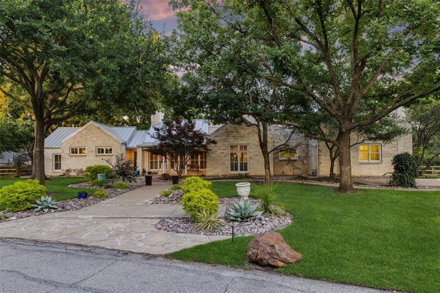 Exceptional Estate in Coveted North Lake Woodlands! Offering timeless curb appeal, the home is surrounded by lush, manicured landscaping, mature shade trees, a charming front porch, and a sleek metal roof — all setting the stage for its warm & inviting ambiance. Set on a generous 0.622-acre lot, this 4-bedroom, 4-bathroom residence spans nearly 5,200 SF of elegant living space. A side-entry 3 car garage & an expansive driveway offer ample space for parking, recreation, or even an impromptu game of basketball. Inside, the grandeur continues w-a vaulted living room showcasing stunning wood-beamed shiplap ceilings, a floor-to-ceiling stone fireplace & custom built-in entertainment center. Rich hand-scraped HW floors and a wall of windows flood the space w-natural light, creating an ideal setting for relaxed evenings or upscale entertaining. Formal dining area exudes sophistication w-a dramatic chandelier & built-in hutch, while the gourmet kitchen is a chef’s dream, featuring a center island, granite, stainless steel appliances, built-in refrigerator + a gas cooktop. Cozy breakfast nook! A spacious nook w-a built-in desk provides the perfect space to work from home or plan the day. French doors lead to a secondary living area, offering serene views of the resort-style backyard. The game room, designed w- sports enthusiasts in mind, includes custom built-ins and themed décor, right down to yard-line carpet — a true fan favorite! Retreat to the spacious primary suite, a relaxing haven w-ample room and comfort, while each guest bedroom offers generous proportions & thoughtful details. The outdoor living space is equally impressive — a sparkling pool with heated spa, covered patio with built-in grill, and an expansive open area perfect for entertaining or simply enjoying peaceful Texas evenings under the stars. Located in the highly acclaimed Coppell ISD and just minutes from DFW Airport, Dallas, and Fort Worth, this home also enjoys proximity to beloved local attractions!