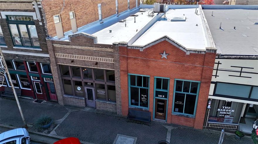 An exceptional offering featuring two commercial buildings in the heart of downtown Athens. This fully renovated professional office space—updated since the mid-1990s—offers a highly functional layout with multiple private offices, four conference rooms, two reception areas, two waiting rooms, two break rooms, ample storage, four bathrooms, 8 designated parking spaces, and new vinyl white roof in 2025. The property currently generates approximately $4,000 in monthly rental income, primarily from attorney tenants, with additional space available to lease for increased revenue potential. These properties can also be joined to be one large building if desired. Located adjacent to the downtown courthouse, this high-visibility location benefits from steady traffic exposure with approximately 6,155 vehicles passing daily per TXDOT. Whether for owner-occupancy, professional use, or investment, the possibilities are numerous in this well-positioned downtown property offering abundant office space and strong income potential.