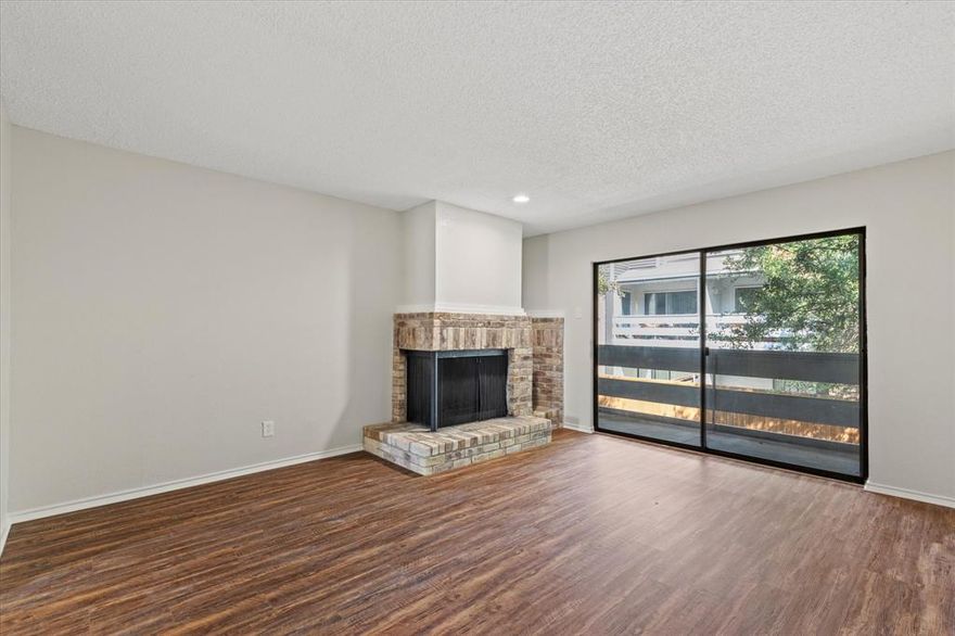 Welcome to this beautifully updated two-story condo nestled in the gated community of Preston Racquet Club. This 2 bedroom, 2.5 bath home features a fresh neutral painted interior and gorgeous wood-look Luxury Vinyl Plank floors throughout the entry, dining area and living room. Enjoy entertaining friends and family in the spacious living room highlighted by a cozy wood-burning fireplace. Whip up a home-cooked meal in the fully equipped kitchen updated Quartz counter-tops, rich wood cabinetry, Stanless Steal appliance package (25) with built-in microwave, electric range and everything you need to prepare your favorite meals. Fresh carpet leads upstairs to two split bedrooms, each with ensuite baths with Quartz counter-tops and walk-in closets. The utility room is also thoughtfully located on the third floor. Lastly, unwind at the end of the day on your private balcony, complete with a storage closet. Residents enjoy exclusive access to community amenities including a sparkling pool, clubhouse, fitness center, racquetball court, and business center. Don't miss the opportunity to make this move-in ready condo your new home! Title Opened at Trust Title