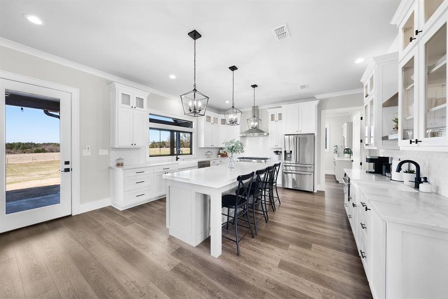 Welcome to this immaculate country retreat, perfectly situated on 2 serene acres just 10 minutes from Sulphur Springs and 5 minutes from the Country Club. This stunning property offers a spacious and versatile layout with 4 bedrooms, 3.5 baths, and an array of thoughtful features designed for comfort and convenience.

The heart of the home is a living area that seamlessly flows into the chef’s kitchen, where you'll find a commercial gas range, marble countertops, a large island, and a charming coffee bar complete with a second sink. The primary suite offers a peaceful sanctuary with a spa-like ensuite bath featuring a double vanity, sleigh soaking tub, separate shower and a custom walk-in closet.

Downstairs, you’ll also find a dedicated office, a large laundry room, a walk-in pantry, a guest half bath, and an oversized attached garage. Upstairs offers even more flexibility with a second living room, a second primary suite, and two additional bedrooms that share a hall bath, all with walk-in closets — ideal for guests or family.

Outdoor living shines with spacious covered porches, including a rear porch equipped with an outdoor sink — perfect for entertaining. Additionally, the property boasts a second detached one-car garage with an extra storage area and an attached dog kennel for your furry friend.

This property effortlessly combines modern luxury with practical amenities, offering a peaceful yet convenient lifestyle. Don’t miss your chance to call this extraordinary home your own!