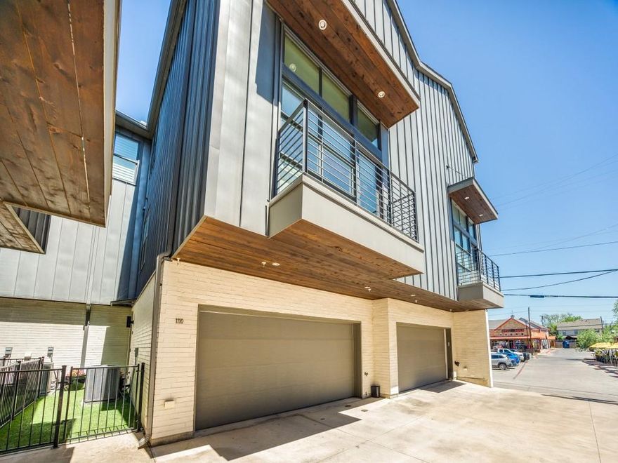 Discover modern elegance at 5202 Capitol Avenue #1110, a stunning three-level corner townhome situated in the vibrant Knox-Henderson neighborhood. Built in 2017, this residence boasts 1,584 square feet of luxurious living space with two bedrooms, two full bathrooms, and a convenient stylishly wallpapered half bath. Enjoy the warmth of hardwood floors, custom window shades, and recessed Lutron lighting throughout. The open floor plan connects a spacious living area with a kitchen, powder bath, and a welcoming balcony. The kitchen is a chef’s dream, featuring designer pendant lighting, quartz countertops, a gas range, stainless steel appliances, and a versatile island with a breakfast bar. The primary bedroom suite offers tranquility with a large custom walk-in closet and an elegant bathroom with dual vanities, while the second bedroom includes a private ensuite bathroom. Exterior highlights include a small fenced front yard, a two-car attached garage, and a second-level balcony. Nestled in the Knox-Henderson neighborhood, this home is just minutes from Downtown Dallas and the bustling shops, dining, and entertainment scenes along Henderson Avenue.