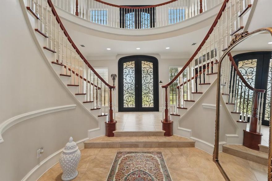 JUST REDUCED AND NEW ROOF! MAKE OFFER. Welcome to this impeccably remodeled five-bedroom, colonial estate, gracefully set on over 2.27 private, tree covered acres. Located within the highly acclaimed Mansfield Independent School District, this residence offers a rare blend of classic antebellum architecture and refined modern luxury in a peaceful, horse-friendly community. A grand double-door entrance opens into a dramatic twenty-four-foot foyer, crowned by a striking medallion glass chandelier and anchored by a sweeping double staircase wrapped in custom woodwork. Inside, nearly five thousand square feet of living space are finished with rich wood paneling, granite surfaces, intricate millwork, and multiple fireplaces that add warmth and character throughout. The expansive gourmet kitchen is designed for both daily living and large-scale entertaining, featuring a paneled refrigerator, butler’s pantry, and two spacious pantries. The primary suite offers a true retreat with its private sitting area, fireplace, custom coffee bar, Luxury stone clad bathroom with steam shower, soaking tub, dual vanities, and two walk-in closets. A main-level mother-in-law suite provides privacy and convenience for multi-generational living. Additional living spaces include a formal dining room, library, family room with built-ins, and an upstairs bonus or media room ideal for work or leisure. This home also includes energy-efficient upgrades, smart home technology, and recently replaced multi-zone HVAC systems, ensuring modern comfort and performance. Outdoor living is just as inviting, with covered porches, manicured landscaping, an aviary barn, and accommodations for horses. The gated, fully fenced lot offers perimeter security and a three-car garage, combining functionality with peace of mind. Every element of this estate has been thoughtfully curated to deliver exceptional comfort, style, and privacy in one of Burleson’s most sought-after communities. Virtual Tours Available.