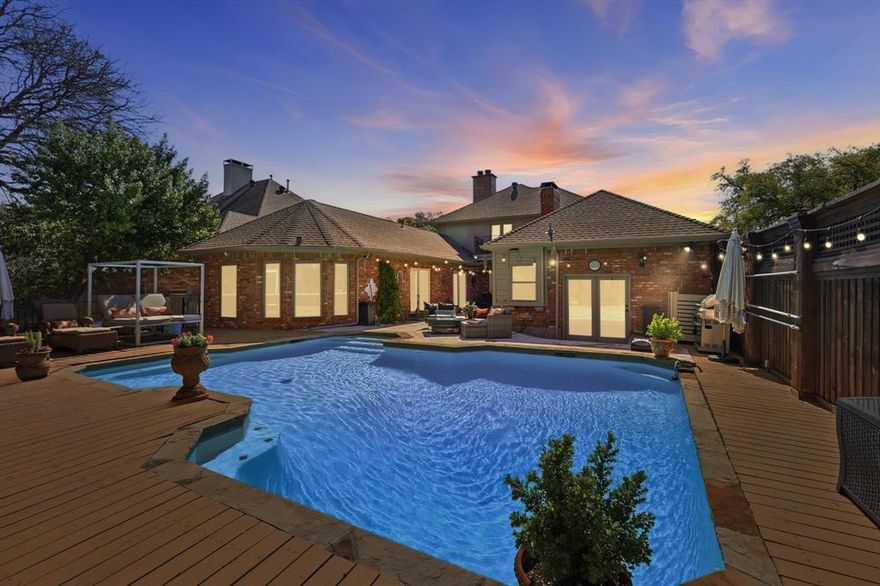 Set on a rare and private creek lot in Addison, this one-of-a-kind residence offers serene living surrounded by mature trees and tranquil water views. Designed to maximize natural light and peaceful outdoor connections, the home blends spacious interiors with multiple outdoor retreats. The main level features an exceptional primary suite with the rare luxury of separate his-and-hers bathrooms and walk-in closets. Down the hall, a versatile space currently used as a workout room can easily serve as a fourth bedroom and includes its own private exterior entrance, ideal for guests, a studio, or home office. This wing overlooks a stunning courtyard and pool with beautiful creek and tree-lined views. A private guest suite with ensuite bath is also located on the first floor. Large windows throughout the main living areas bring in abundant natural light and frame views of the lush backyard. The updated kitchen features quartz countertops and stainless steel appliances and opens to a bright living area overlooking the pool, deck, and surrounding greenery. Outdoor spaces are thoughtfully designed for relaxation and entertaining, including a private courtyard with a separate spa near the primary suite and a convenient poolside half bath. Upstairs, a sitting area leads to a spacious bedroom suite with full bath and balcony overlooking the backyard and creek—perfect for enjoying the peaceful setting. The property offers several quiet outdoor spaces to relax or unwind. Addison residents enjoy access to the Addison Athletic Club, featuring parks, walking trails, pool, tennis, and volleyball courts. Ideally located near shopping, dining, and the Dallas North Tollway, this remarkable creekside home offers privacy, versatility, and an exceptional Addison lifestyle.