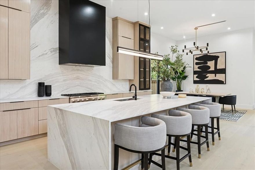 There’s a moment when you step inside — 22-foot ceilings and walls of glass frame a California
ease unexpected in Lakewood. This is architecture as experience, where the tactile warmth of
Venetian plaster and the precision of bespoke stonework create a sense of grounded, quiet
permanence.
The entry commands attention: a sculptural fireplace anchors the double-height space, while a
floating glass staircase with motion-activated LED lights draws the eye upward. It’s drama
without pretense. In the kitchen, a 12-foot waterfall island and Thermador appliances meet rift-
cut oak cabinetry. A hidden, Bosch-equipped back kitchen keeps the main stage clear for
entertaining.
The floor plan is an exercise in social choreography: a glass wine display serves as a central
focal point, while the wet bar is perfectly positioned to carry guests between the media and
game rooms.
The downstairs primary suite with a spa-inspired bath offers a serene departure from the
gathering spaces, while a separate, moody guest suite ensures privacy. Upstairs, three
additional en-suite bedrooms join a media room and a flexible space for a gym or studio.
The experience culminates in the sunken, multi-level backyard. Glass walls slide away, blending
light-filled interiors with an effortless outdoor flow. This creates a natural footprint for a custom
pool to complete the sun-drenched retreat.
A rare lifestyle offering, situated minutes from Lower Greenville’s vibrant culinary scene, the
scenic trails of White Rock Lake, and high-end shopping &amp; dining in the heart of Dallas.
This isn't just new construction; it’s a fully realized vision — bold, refined, and uncompromising.