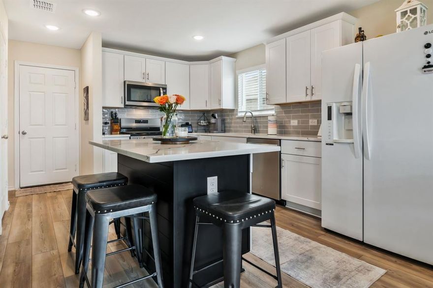 This home is an absolutely stunning, light-filled and effortlessly stylish, this single-story home in Haslet offering modern design and low-maintenance living. LVP flooring flows throughout the spacious open floor plan, creating a warm and inviting feel. The living room with its stylish accent wall offers a tray ceiling and opens to the dining and kitchen area with eat-up island, quartz countertops, a stylish tile backsplash, and an upgraded sink that make both cooking and entertaining a breeze. The primary suite is a true retreat, with a marble double vanity, metal framed arched mirrors, and a custom-built closet with added storage. The upgrades continue throughout with upgraded plumbing and light fixtures elevating every space. Step outside to the expansive private backyard with an extended patio, perfect for relaxing or hosting gatherings. Plus, enjoy the perks of a finished & painted garage with epoxy floors and access to neighborhood trails and a playground just minutes away. Ample nearby recreation, shopping and dining makes this Elizabeth Creek property a great place to call home for your next lease! Refrigerator, washer and dryer included!