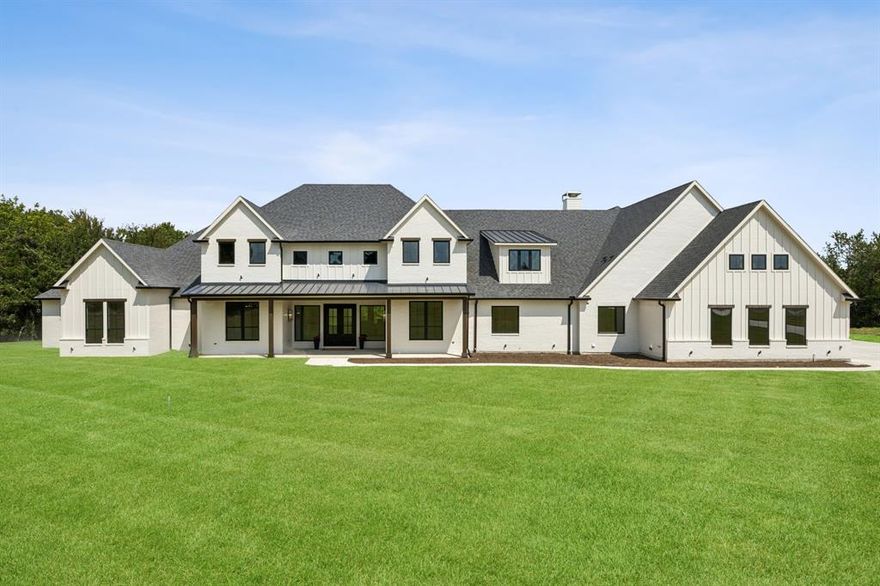 Located in the prestigious Hills of Lone Star, this brand-new custom estate is set on a premium 6-acre cul-de-sac lot with lush greenbelt views and a Bee Ag exemption on 5.5 acres for significant tax savings. Spanning 8,299 square feet, the home lives like a one-story with 7,467 square feet on the main level and features 6 bedrooms, 6.5 baths, and 5 versatile living areas including a game room, media room, and study. The striking exterior of white brick accented with warm wood sets the tone for the luxury within. A chef’s kitchen offers dual white oak islands, Thermador appliances including a 60-inch commercial range and 72-inch fridge-freezer, a full catering kitchen, and an oversized walk-in pantry. The private owner’s retreat boasts a spa bath with soaking tub, dual vanities, and an oversized custom closet with laundry. Throughout the home, you will find solid white oak floors, beamed ceilings, stone fireplaces, retractable sliders, inset cabinetry, and thoughtful spaces such as a mudroom with 10 custom lockers and a large utility room. Outdoor living is equally impressive with a 50-foot covered patio featuring a fireplace, dedicated pool bath, gas stubs for a summer kitchen, and upgraded landscape lighting. An oversized 4-car garage plus graded parking pad complete this rare opportunity to own a brand-new, never-lived-in estate in one of the area’s most coveted communities.