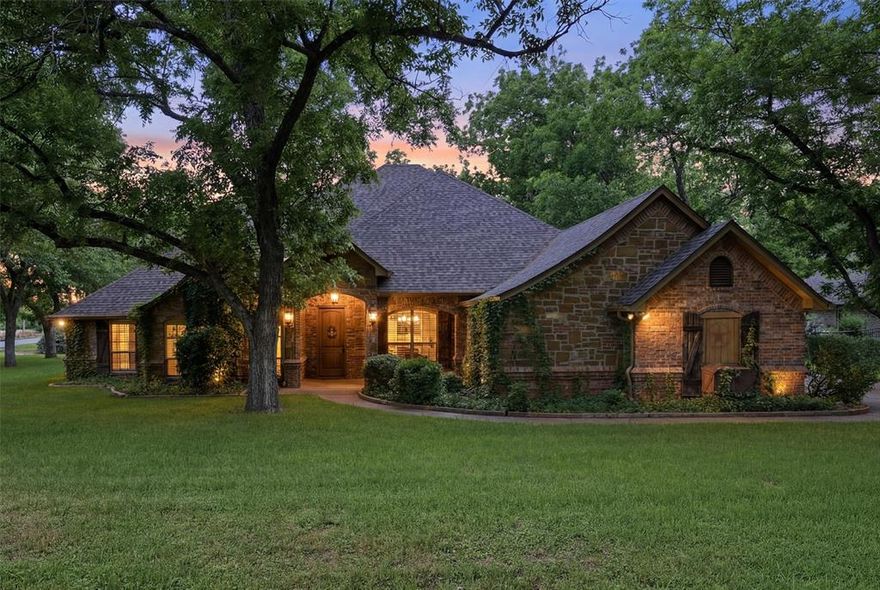 Welcome to an extraordinary custom built residence in the prestigious Pecan Plantation community, where timeless elegance and exceptional craftsmanship come together to create a truly remarkable home. From the moment you arrive, the gorgeous exterior and striking curb appeal of this large corner lot set the tone for what awaits inside.

Step through the doors to discover rich woodwork and custom details woven throughout the home, creating warmth, sophistication, and character in every room. Designed for both luxurious living and comfortable everyday life, this home features three fireplaces that add charm and ambiance across multiple living spaces and kitchen.

The dedicated office or library is nothing short of impressive. A refined retreat ideal for working from home, hosting clients, or simply enjoying a quiet space with beautiful architectural detail. Expansive living areas flow seamlessly into the heart of the home, offering the perfect setting for entertaining guests or gathering with family.

One of the standout features is the incredible screened-in covered patio, providing a year-round outdoor living experience where you can relax, entertain, and enjoy the beauty of the surrounding property in comfort and style.

This home features an oversized double garage with an additional 3rd garage that has been heated and cooled. Walk up stairs in garage lead to an impressive attic that is decked for abundant storage.

Located within one of North Texas’ most sought-after gated golf course communities, residents of Pecan Plantation enjoy an unmatched lifestyle with access to golf, dining, parks, recreation, airstrip access, equestrian facilities, and more. This is more than a home — it’s a lifestyle defined by luxury, comfort, and community.