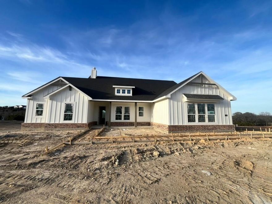 Ask us about our Trade In Trade Up program, we can buy your home! Stunning interior with abundant natural light, treed homesite located on 1.6 acres in a serene, quiet community with a tranquil creek at the back. Cozy and roomy interior for country family living. There is irrigation in sodded areas along with a drip system under flowerbeds. This homesite boasts, a spacious yard with beautiful mature trees for natural privacy and large covered patio to enjoy the scenery. MASONRY FIREPLACE, COVERED PATIO, FULL FOAM INSULATION, ENERGY EFFICIENT BUILDER!