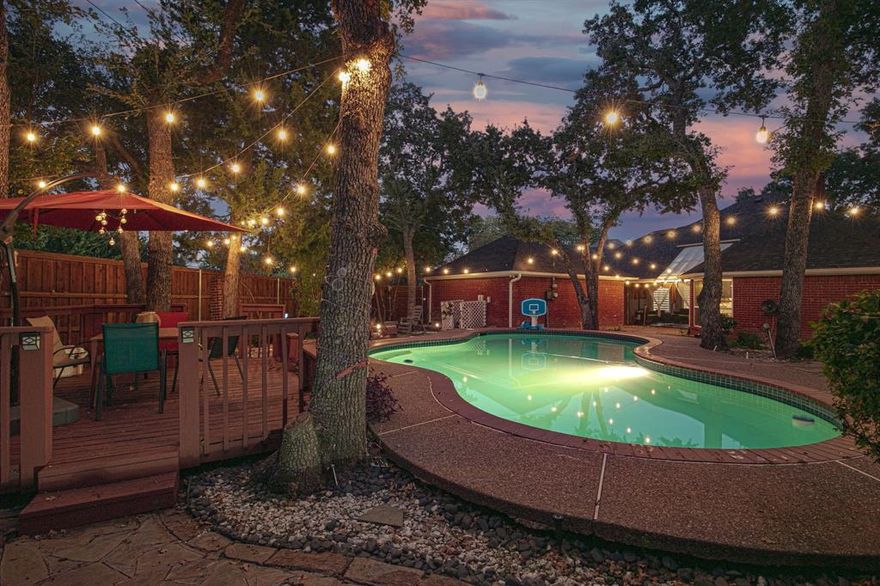 Located minutes away from your favorite sports stadiums and Arlington’s entertainment district and we are PRICED TO SELL. Tucked away on a quiet cul-de-sac in North Arlington’s coveted Tiffany Park-Woodridge neighborhood, this beautifully updated 4-bedroom, 3-bath home offers the perfect blend of peaceful living and vibrant city convenience. Whether you're hosting lively gatherings or seeking your own private retreat, this home delivers on every level. Inside, you'll find a spacious single-story layout with a smart 3-way bedroom split—perfect for multi-generational living or overnight guests. Two generous living areas are connected by a stunning dual-sided fireplace and a built-in wet bar, creating a warm, inviting space for entertaining. The kitchen is the heart of the home, featuring granite countertops, stainless steel appliances, a center island, double ovens, pantry, and breakfast nook—ideal for everyday living and holiday hosting. The primary suite is privately situated and includes dual vanities, a soaking tub, and a separate shower. One secondary bedroom includes a built-in safe room and custom bookcase, offering both comfort and peace of mind. Step outside to your backyard oasis where entertaining continues. Cool off in the in-ground sport pool, grow your own herbs or veggies in the 50 sq ft greenhouse, or work on projects in the fully equipped workshop with electricity and water—an entertainer’s dream with room for hobbies and relaxation alike.
Additional highlights include: Recent foundation work with transferable warranty. Low-maintenance tile and laminate flooring throughout. No HOA
Mature trees and landscaping. Oversized 2-car garage with ample storage and ALL of this just minutes from I-30, DFW Airport, AT&T Stadium, Globe Life Field, Texas Live and Arlington’s entertainment district. Enjoy the best of both worlds Fun and Comfort