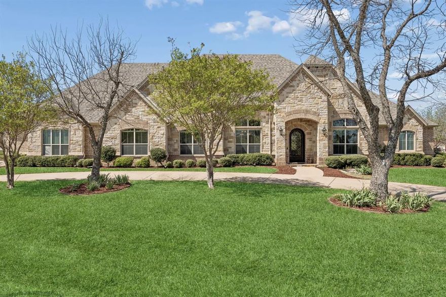 This beautifully appointed home offers an ideal blend of comfort, style, and location within the highly sought-after Pecan Plantation community on the shores of Lake Granbury. Featuring a light-filled, open-concept layout, the spacious living area is designed for both everyday living and entertaining, flowing seamlessly into a massive kitchen with ample cabinetry, expansive counter space, and a huge island that serves as the centerpiece for cooking, gathering, and hosting. The private primary suite provides a relaxing retreat with a spacious bedroom, a well-appointed ensuite bath, and a large walk-in closet. Upstairs, a generous gameroom offers incredible flexibility and could easily function as a second primary suite with its own ensuite bathroom, ideal for guests or multi-generational living. The home also features an incredible office with stunning custom wood built-ins, creating a professional yet warm workspace. Additional bedrooms are well-sized and thoughtfully positioned. Thoughtful finishes, neutral tones, and quality craftsmanship throughout create a warm, move-in-ready atmosphere. Step outside to your own backyard oasis, complete with a large pool featuring a slide—perfect for entertaining, relaxing, and enjoying the Texas summers—along with a spacious covered patio with rocking chairs, ideal for savoring peaceful Texas sunsets. Enjoy tranquil views of a greenbelt just across the street, where deer are often seen, adding to the scenic setting. Located in a premier gated and guarded community, residents of Pecan Plantation enjoy exceptional amenities including access to Lake Granbury, a marina, two golf courses, stables, archery facilities, a clubhouse, swimming pools, parks, walking trails, tennis courts, and two private airstrips, along with convenient on-site shopping, dining, and services. This home offers not just a place to live, but a lifestyle defined by comfort, recreation, and scenic beauty.