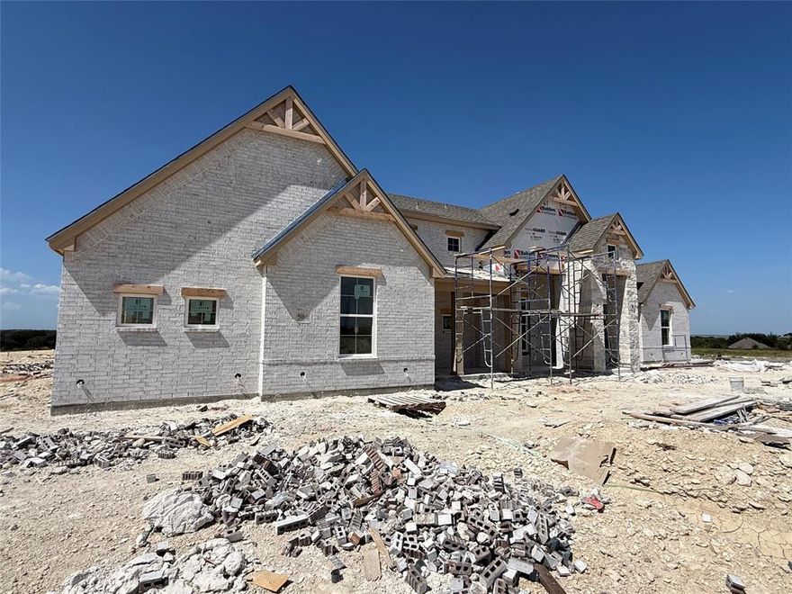 Awesome new plan by Builder in this exclusive new neighborhood in Aledo ISD! White Stone and brick home with black roof, many builder upgrades including Quartz Countertops, Luxury Vinyl flooring throughout all main areas and isolated master bathroom near huge Covered Patio for entertaining. Plenty of extra room on this 1 acre lot, new construction, approximate completion date of October 2025.