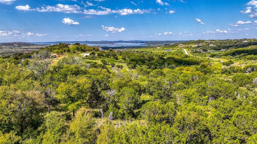 Discover the perfect setting for your dream home in the gated community of The Hills Above Possum Kingdom Lake.  This beautiful 2.02 acre corner lot with an incredible LAKE VIEW offers both space and privacy with easy access to the community's amenities. Enjoy the rolling landscape, peaceful surroundings, and the opportunity to design your ideal retreat just minutes from the crystal-clear waters of Possum Kingdom Lake.  Residents of The Hills enjoy a gated entrance with an infinity pool overlooking the lake, fitness center, dry boat storage area, lakeside community cabin and convenient boat ramp. Whether you're looking to build now or invest for the future, this property provides the ideal comb of security and natural beauty. 


Information deemed reliable but not guaranteed.  It is the buyer and buyer's agent responsibility to verify.