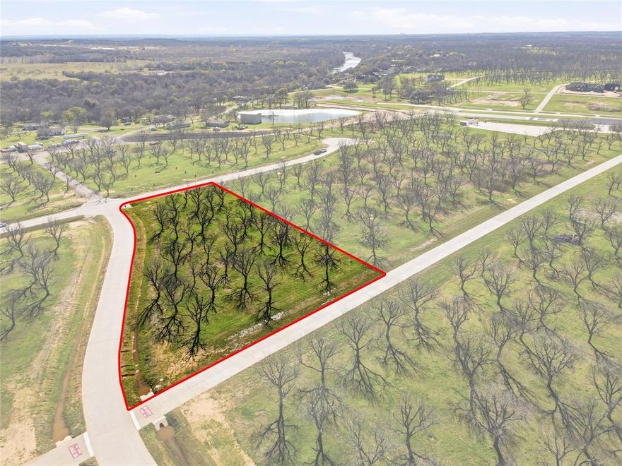 This 1.6 Acre corner lot offers an exceptional opportunity to build your custom home AND hangar of choice. Enjoy once of Texas' most unique residential airpark communities. This particular lot has direct taxiway access and is currently located with convenient access to the runway and fuel station. This one of a kind community offers country club living with two golf courses, a marina, tennis, pickleball, swimming pools, equestrian center, an activity center, restaurants and more! All surrounded by the natural beauty of mature pecan trees. A rare opportunity for pilots to enjoy both aviation and the convenience of resort style living.