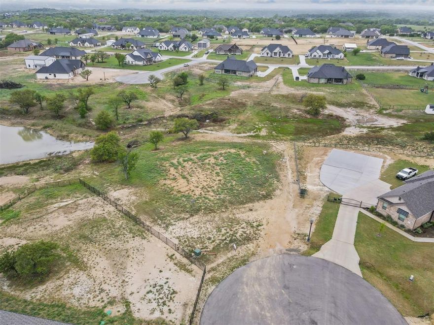 Discover the perfect spot to bring your dream home to life in the desirable Calhoun Acres subdivision in Azle, TX. This spacious 1-acre lot is cleared and ready to build, offering a beautiful and peaceful setting with a serene pond view right in your backyard. Located in the highly-rated Azle ISD, this property combines the charm of country living with the convenience of nearby city amenities. Enjoy the open space, scenic surroundings, and the freedom to create a custom home, pool, and shop tailored to your lifestyle. For the commuters, Azle is located about twenty minutes from Ft. Worth and Weatherford.