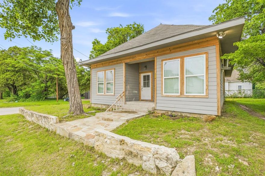 Located just minutes from downtown Fort Worth, this fully taken down to the studs and completely rebuilt home offers the feel of new construction with modern finishes and a unique, spacious layout throughout. Everything has been redone including electrical, plumbing, HVAC, insulation, drywall, flooring, fixtures, and more, providing peace of mind for years to come. The open-concept living, dining, and kitchen area features soaring ceilings, abundant natural light, luxury vinyl plank flooring, recessed lighting, and a spacious island kitchen with granite countertops, stainless steel appliances, and custom cabinetry. The oversized primary suite offers flexibility for a sitting area or office along with a beautifully updated ensuite bath featuring a large walk-in shower and dual vanity. Secondary bedrooms are generously sized with versatile use options. Home is equipped with multiple mini split systems for efficient zoned heating and cooling. Exterior updates include fresh paint, cedar trim accents, and a large newly built wood deck overlooking a spacious backyard with mature trees. Conveniently located near downtown Fort Worth, the Stockyards, Panther Island, dining, entertainment, and major highways, making this an ideal primary residence, rental, or investment opportunity.