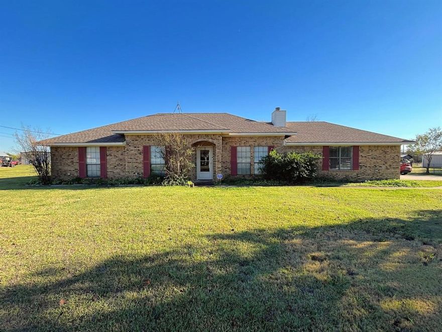 This attractive and well-built home sits on 1.49 acres in the highly regarded Palmer ISD, and offers peaceful country-style living.  Inside, you’ll find a spacious living room with a striking floor-to-ceiling fireplace, soaring 12-foot ceilings in select areas, fresh paint in many rooms, and durable vinyl plank flooring throughout.  The generous primary bedroom includes a well-appointed ensuite bath with a double vanity, garden tub, and separate shower, while the delightful kitchen offers an abundance of cabinet and counter space.  The dining area, open to the living room and adjacent to the kitchen, provides the perfect setting for everyday meals and gatherings.  From the dining area, step out onto the sizable covered patio to extend your living and entertaining space outdoors.  The property also features a slightly oversized two-car attached garage and a separate storage building to meet all your storage needs. With 1.49 acres, the lot offers exceptional versatility with ample room for RV parking, building your dream workshop, enjoying recreational activities, or keeping the animals of your choice.  Conveniently located near shopping, dining, entertainment, and medical facilities in Waxahachie, with quick access to I-35 and I-45 for commuting to the Dallas Metroplex for employment oppportunities, this home combines comfort, space, and location.  For added peace of mind, the water heater, HVAC, and roof have been updated in recent years.  This home is ready to welcome its next owner, so Schedule Your Viewing Today!