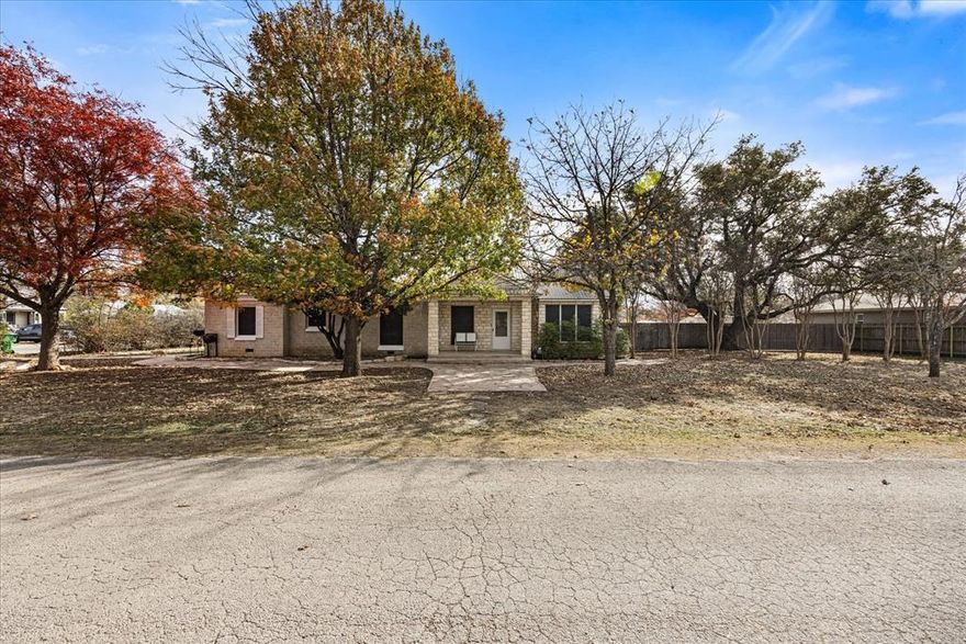This spacious home sits on a large corner lot with many trees. The primary suite has dual vanities, separate shower, separate tub and two walk-in closets. The other bedrooms are split from the primary, one has a large walk-in closet, the other built in storage, laundry connections in the closet and both have wood flooring. All the closets have custom built-in shelving. The kitchen is open with dual ovens, gas cooktop and walk-in pantry. There is also a pass through to the dining room and lots of built-in storage. The sunroom also features build-in cabinetry along with a pellet stove and window seat with storage. The sunroom, living and dining also have beautiful planation shutters. There are ceiling fans throughout the entire, even in the kitchen and primary bath. Outside you'll find a covered patio with ample space for seating and entertaining. There is a 3 car garage with 3 workshop areas, and two portable storage buildings that could be removed for more yard space.