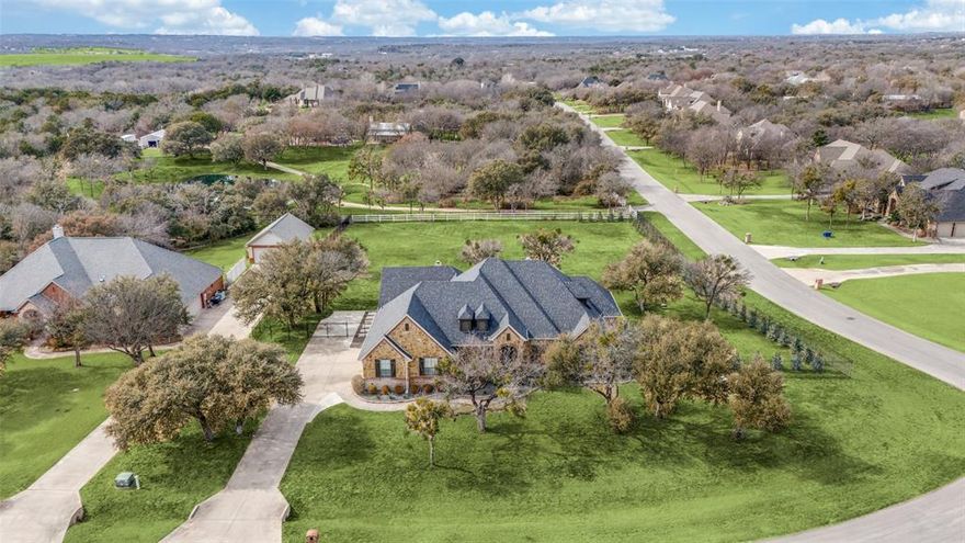 Set on a fully fenced, cul-de-sac lot in Fort Worth's exclusive Arbor Mill neighborhood, where all fifty-six custom homes are on leafy acre-plus lots with deep setbacks for the ultimate in privacy. This home has been extensively improved and upgraded for long-term, low-maintenance ownership. Nearly every major system has been recently replaced or upgraded, including the roof, gutters, HVAC with new ductwork and spray foam insulation, well pump and water softener, aerobic septic components, irrigation system, and all fencing. Inside, updated flooring, quartz surfaces, plumbing fixtures, lighting, and appliances create a clean, neutral, and cohesive interior that will require little upkeep for many years to come. The outdoor living area is a true extension of the home, designed for both daily use and entertaining. This fully insulated, roof-integrated pavilion features epoxy flooring, remote solar screens, oversized fans, surround sound, a gigantic screen media setup, and a wood-burning fireplace. The Blaze® outdoor kitchen is fully equipped with a grill, griddle, double pot burner, vent hood, sink, refrigeration, beer tap, and generous prep space with fabulous quartzite waterfall countertops. It is a turnkey environment for hosting and entertaining with ease. Practical enhancements continue throughout the property, from Wi-Fi-controlled irrigation and drought-tolerant landscaping with 70 Nellie Stevens privacy hollies along the fenceline to a climate-controlled garage and energy-efficient systems. With well water, no city taxes, and a very low annual HOA fee, your operating costs will remain firmly under control. This is a home built for simplicity and ease, where the focus stays on living enjoyment, and removes the need to mechanically upgrade or improve well into the future. Azle schools enjoys one of the lowest teacher-student ratios in the State, and many natural environment amenities like lakes, parks and hiking areas are minutes away.