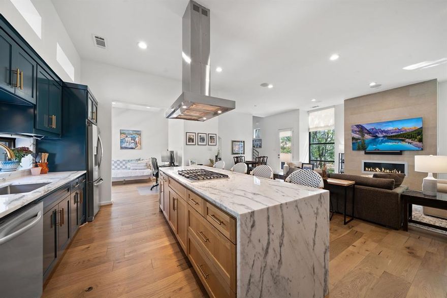 This thoughtfully updated 2-bedroom, 2.5-bath urban residence with a dedicated office space blends modern style with everyday comfort. Large floor-to-ceiling windows flood the home with natural light, enhancing the clean, contemporary feel. The kitchen has been tastefully redesigned with quartzite countertops, a white oak island with a waterfall edge, stainless steel appliances, a wine fridge, and refreshed cabinetry with updated hardware. It opens directly into a spacious living area centered around a gas fireplace. The primary bathroom has been recently renovated and features new tile flooring and a fully updated shower. White oak hardwood floors run throughout the home, adding warmth and a refined finish. Located in a sought-after area with close proximity to popular destinations, including Knox-Henderson and Lower Greenville, offering a variety of dining, shopping, and entertainment options. Step outside to a rooftop terrace with sweeping downtown views—ideal for entertaining or unwinding. The gated backyard offers additional outdoor space, perfect for pets or relaxing.