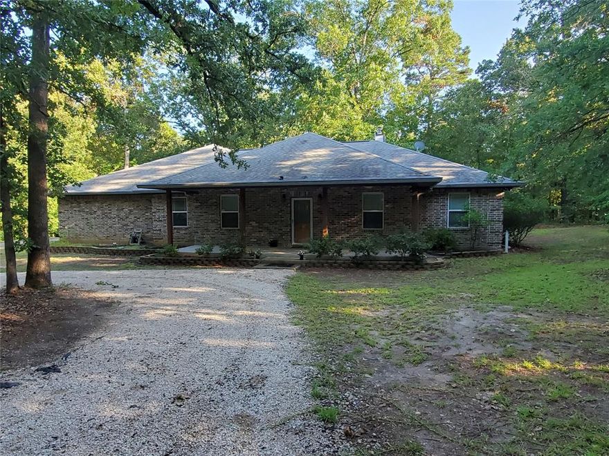 Charming home in peaceful gated community. NEW ROOF & WINDOWS on this 4bd-2.5bth-2-car-shop on 3.45 wooded acres surrounded by towering pines, oaks, dogwoods.  Open floor plan with cozy living room with wood burning stove, kitchen features custom solid wood cabinets, built-in oven, microwave, Corian countertops, spacious island and large walk-in pantry. Breakfast nook, separate dining, large laundry to accommodate full-size deep freezer. Master has custom built-in desk; master bath with double vanities, walk-in shower with grab bars, huge walk-in closet. Oversized garage is hobbyist dream with workspace, cabinets, drop-down tables, utility closet, office, portable generator.  Attached shop is heated & cooled with cabinets, work table and dust collection system. The covered patio and deck are perfect for watching wildlife while enjoying your morning coffee or evening beverage. Information deemed reliable but not guaranteed; should be verified by Buyer and Buyer's Agent.