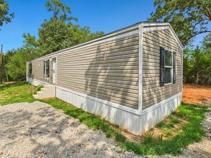 Price Reduction!
Tucked away on 5 wooded acres just outside the city limits, this beautifully refreshed 3-bedroom, 2-bath mobile home offers the ultimate in peace and privacy. Surrounded by trees, you’ll feel a world away while still being conveniently close to town. The home features a split floor plan and an open, inviting layout that feels like new, with all kitchen appliances included for easy move-in. Whether you dream of relaxing in total seclusion, adding a shop, or bringing your animals, this property gives you endless possibilities. Experience the quiet, private country lifestyle you’ve been searching for now at an even better price!