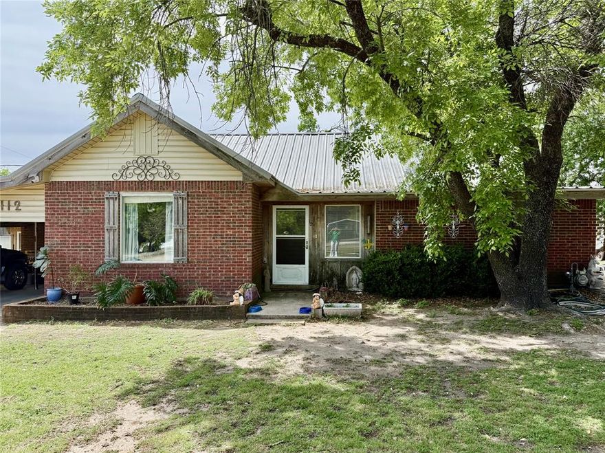 This well-maintained brick home sits on a generous 0.72-acre lot in a highly versatile commercially zoned area of Hamilton, offering endless potential for residential living, business use, or investment. A durable metal roof provides long-term value and low-maintenance appeal, while mature oak trees shade the expansive yard, creating a welcoming outdoor setting.

Inside, the home offers a functional 3-bedroom, 2-bath layout with abundant storage throughout. The spacious primary suite features a large bathroom and closet. The bright, open kitchen is equipped with new Samsung matching stainless steel appliances that convey with the sale. The third bedroom offers flexibility as a den or playroom, and an additional bonus space off the laundry room is ideal for a home office setup.

Outdoors, the property is well-equipped for a variety of uses, featuring a greenhouse just off the two-car carport, two new storage sheds, additional outbuildings, and a storm cellar. Whether you're looking for space to garden, run a home-based business, or simply enjoy extra room to spread out, this property delivers flexibility and opportunity in a convenient setting.