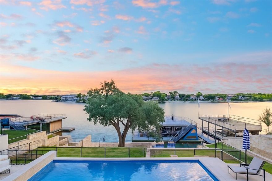 FIRST TIME OFFERED FOR SALE IN HIGHLY DESIRED LEGENDARY ESTATES ON LAKE LBJ. This gorgeous Keith Wing Modern Transitional WATERFRONT custom home is positioned on the Colorado arm of Lake LBJ & sits high & beautifully on .68 ac with stunning views of Packsaddle Mtn., Lookout Mtn, & the entire Hill Country as the backdrop to LAKE LBJ. Having a gorgeous home & pool w- a large gentle sloping backyard featuring a Century Oak that helps shade the private beach & fire pit areas down by the massive boat dock is a unique feature as well. The artfully planned boat dock is two levels & has hydraulic jet ski lift-platforms for 4 jets skis, planned spaces for kayaks, fishing dock, private slide into the lake, & two large hydraulic boat lifts complete w- electric boat garage covers. The upstairs deck is designed for entertaining & or relaxing under the sun & stars, making lasting memories & enjoying views for days! Completed in late 2020, this home of 5,054 sqft is open w- a flexible floorplan w- large rooms, built for family & many friends w-out feeling crowded or compromising privacy. The large metal front door welcomes you into the main LR, DR, Kitchen, & 2nd LR complete w Wet bar & all rooms encompassed with custom black iron windows & collapsible iron doors out back to the upstairs liv. areas & outdoor kitchen w- island. All windows have top tier powered shades & a smart lighting system inside & out. 2 primary suites w- 2 primary baths on the 1st level & upstairs, 3 very large bedrooms w- en-suite baths plus a bunk room w- 4 built-in full-size bunk beds w- an en-suite bathroom. There is a rec room off the bunk room & a large loft game room perfect for pool, ping pong, gaming or even an office-workout room that has auto black out shades that convert the room into another 2 bedroom sized suite. The chef’s kitchen has a large pantry & large laundry & mud room off the 3-car garage w- attached commercial W-D for towels & there’s a golf simulator too!