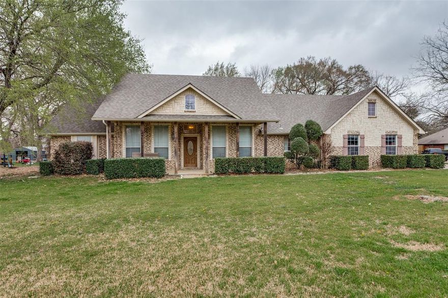 Nestled on over 1 acre in highly sought-after BISD, this beautiful country property offers the perfect blend of peaceful living and convenient access to I-35. This spacious home features 4 bedrooms, 2 bathrooms, and two living and dining areas, providing plenty of room for both everyday living and entertaining.

Inside, you'll find stained concrete and hardwood flooring, an open-concept floor plan, and a stunning floor-to-ceiling stone fireplace that serves as the centerpiece of the family room. The oversized kitchen and breakfast nook offer ample space for gatherings and feature a breakfast bar and stainless steel appliances.

The private primary suite is a true retreat, complete with a see-through fireplace connecting the bedroom and master bath. A split-bedroom layout provides added privacy for family or guests.

Step outside to enjoy the large covered patio overlooking a beautiful treed backyard, perfect for relaxing evenings or entertaining outdoors. With country charm, modern comforts, and a convenient location, this property truly has it all.