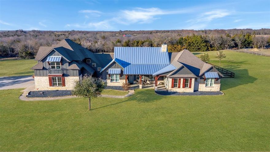Rare opportunity to own a private lakefront estate on approximately 9.056 tree-lined acres in Gunter, located outside city limits with no HOA. Perched on a hilltop, the property offers expansive water views and a peaceful setting while maintaining convenient access to nearby growth corridors. The custom-built residence spans approximately 4,070 square feet and includes 4 bedrooms, 4 bathrooms, a dedicated office, formal dining area, and a spacious game room. The main living area features vaulted ceilings and a floor-to-ceiling stone fireplace, creating a warm and inviting focal point. Designed for both everyday living and entertaining, the outdoor space includes a heated pool, spa, swim-up bar with covered pergola and in-ground barstools, and a fully equipped outdoor kitchen. The acreage is fenced and offers flexibility for a variety of uses, with open land, mature trees, and a scenic lake enhancing the overall setting. Additional improvements include an oversized 4-car garage, a 30x40 workshop, a loafing shed and barn, a 20 kW Generac propane generator, and a reinforced concrete storm room. Conveniently located with access to Preston Road, FM 121, and the future Dallas North Tollway expansion, and served by Gunter ISD. A unique property offering space, functionality, and long-term potential in a rapidly growing area.