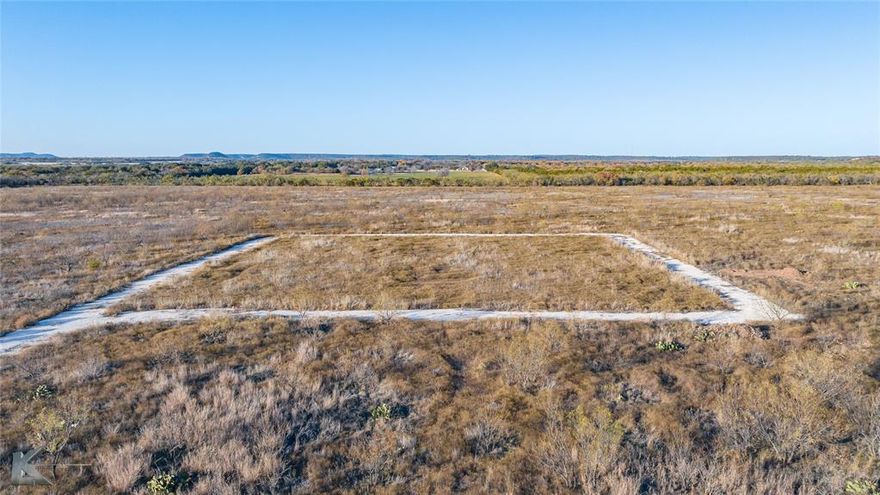 106.15± Acres  Jim Ned ISD Located approximately 4 miles east of Tuscola, Texas, this well-positioned tract offers wide-open, unobstructed views with no power lines or wind turbines impacting the landscape. The property features a new entrance with cattle guard and gravel driveway, two stock tanks, and a water meter available through Steamboat Mountain Water Supply. The land is completely fenced and ready for development, with gently rolling topography accented by two impressive mature live oak trees. Native grasses are in good condition, with fresh growth of smaller mesquite beginning to emerge—manageable with standard chemical application or mechanical grubbing if desired. An excellent opportunity for a homesite, recreational use, or long-term land investment.