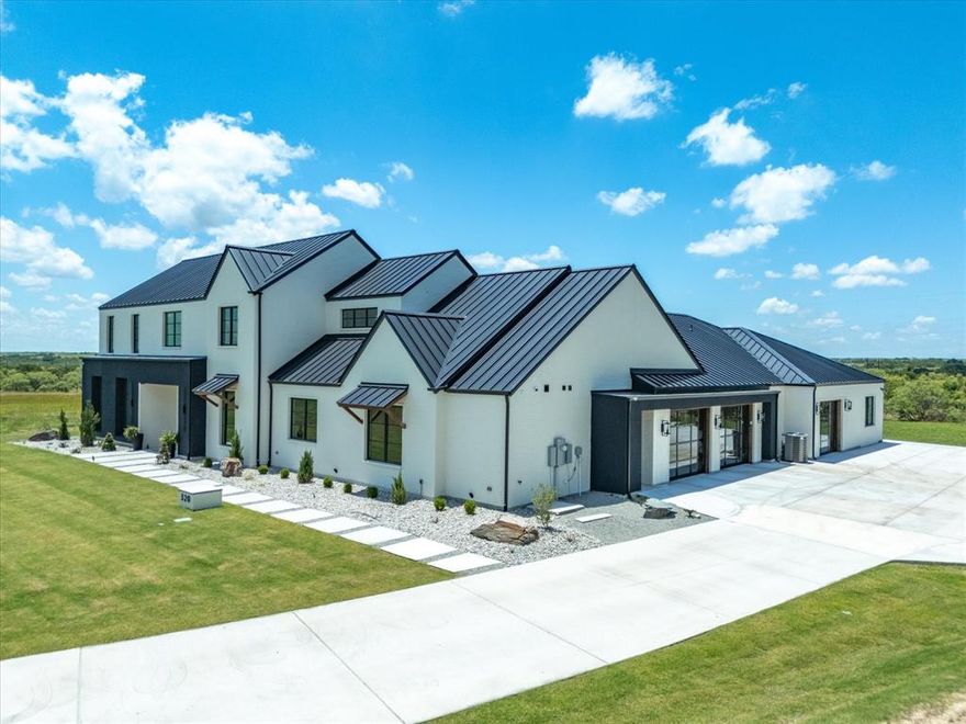 Modern Rustic Refined! MUCH anticipated fabulous new listing just in at 320 San Gabriel Dr. in Aledo’s most exclusive, La Madera Estates is LUXURY redefined! Loaded with the absolute FINEST in interior finishes from floor to ceiling and everywhere in between -- this incredible property spares no expenses. The kitchen is a STUNNER with GORGEOUS color scheme and upgraded commercial appliances, as well as built in SS fridge; plus a luxurious primary spa bath with a closet to die for, full media room, and arguably the most favorite room in the house will surely be the in-home gym with the edgiest bar around that has pull up glass doors that bring the outdoors in. All bedrooms have ensuite baths (each wonderfully done and decorated), plus a full concrete safe-tornado safety room with vault door, high-end glass double entry doors, as well as triple slider exterior doors, 4 car garage spaces each with glass doors, hardwood flooring thru out, and modern on-trend steel roof. Sits perfectly on hilltop lot with stately curb appeal and on a great 3 acre VIEW lot with the prettiest country setting and upscale estate properties all around. Acclaimed Aledo Schools.