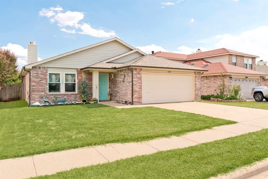 PAID OFF SOLAR PANELS - Keep your house cool all summer with minimal utility bills! This beautifully remodeled home is move-in ready and nestled within walking distance to Marine Creek Lake! Backs up to greenbelt with walking path that leads to the lake. Perfect for walking, running, and enjoying nature! Open floor plan with lots of natural light, bamboo wood flooring, and wood burning brick fireplace with electrical fireplace. Oversized kitchen with ample cabinet space, SS appliances, dishwasher (2023), fridge to stay, eat in space with designer light fixtures, and LARGE walk in pantry! All bedrooms with new carpet (2024). Secondary bathroom with new vanity (2024), tiled shower & tub. Primary bedroom oversized with wrap around walk in closet. Primary bathroom remodeled in Dec. 2024. Updates as of the end of 2024 include: Freshly painted exterior, new Anderson windows, landscaping, light fixtures, primary bathroom, duct cleaning throughout entire home, and shade sail connected to back patio. Refrigerator, electric fireplace, and overhead storage in garage all convey! Don't miss this gem!